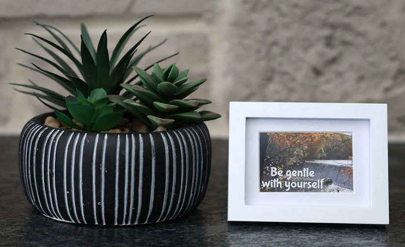 Framed picture with 'Be gentle with yourself' quote.