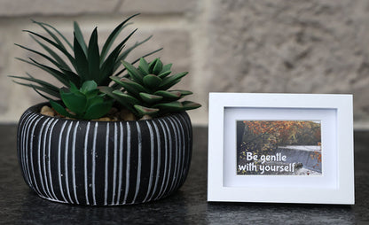 Framed picture with 'Be gentle with yourself' quote.