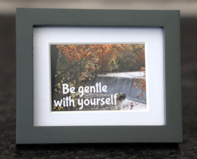 Framed picture with 'Be gentle with yourself' quote.