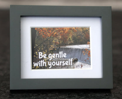 Framed picture with 'Be gentle with yourself' quote.