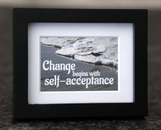 Framed picture with 'Change begins with self-acceptance' quote.