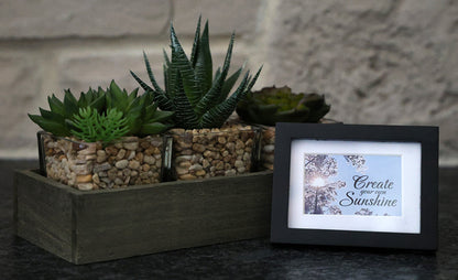Framed picture with 'Create your own sunshine' quote.