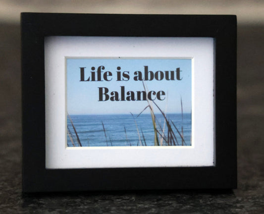 Framed picture with 'Life is about balance' quote.