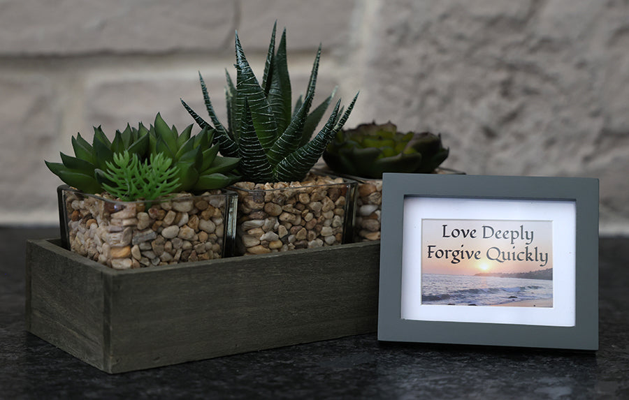 Framed picture with 'Love Deeply, Forgive Quickly' quote.