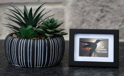 Framed picture with 'Tell someone they matter' quote.
