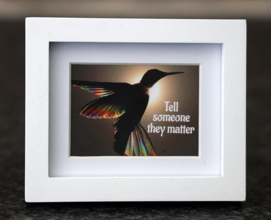 Framed picture with 'Tell someone they matter' quote.