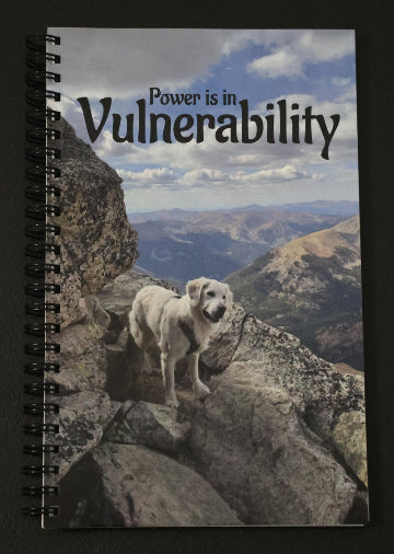 Journal with a dog on a mountain peak on the cover and 'Power is in Vulnerability' text.