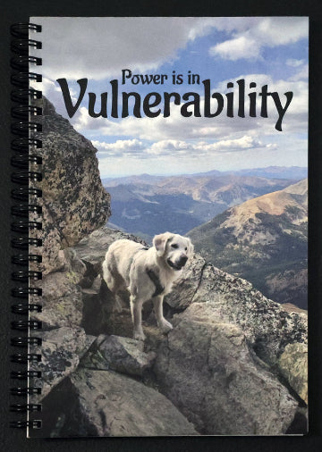 Journal with a dog on a mountain peak on the cover and 'Power is in Vulnerability' text.