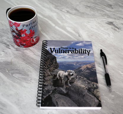 Journal with a dog on a mountain peak on the cover and 'Power is in Vulnerability' text.