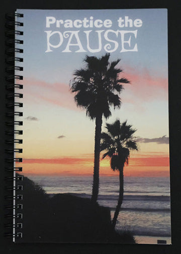 Journal with palm tree silhouette at sunset, with text 'Practice the PAUSE'.