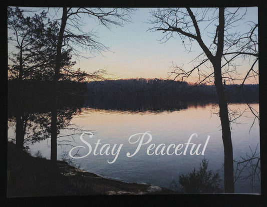 Canvas print with scenic sunset over a lake and trees with 'Stay Peaceful' text.