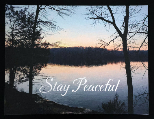 Canvas print with scenic sunset over a lake and trees with 'Stay Peaceful' text.