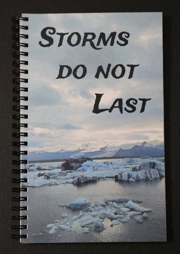 Journal with a scenic cover of icebergs and mountains, featuring the text 'Storms don't last'.