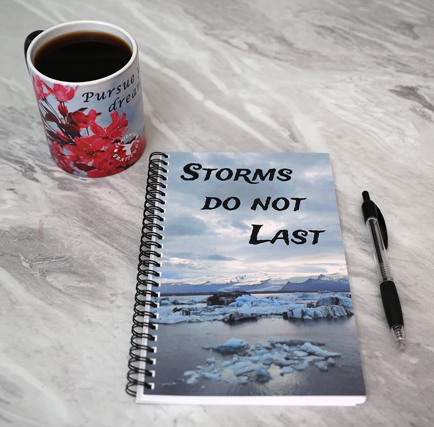 Journal with a scenic cover of icebergs and mountains, featuring the text 'Storms don't last'.