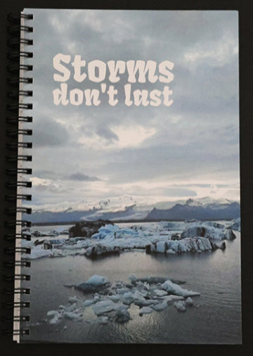 Journal with a scenic cover of icebergs and mountains, featuring the text 'Storms don't last'.