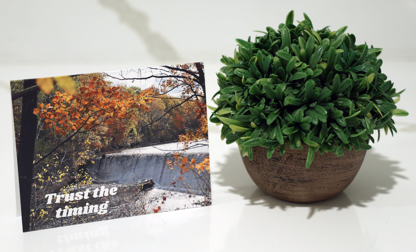 Note card with scenic waterfall and "Trust the timing" quote.