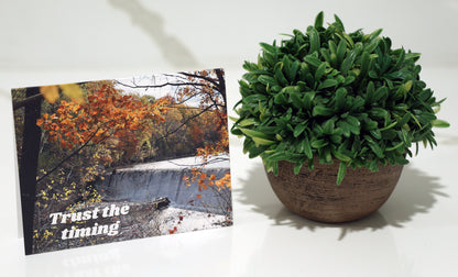 Note card with scenic waterfall and "Trust the timing" quote.