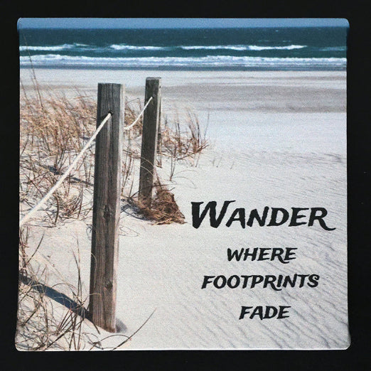 Canvas print with beach scene with 'Wander where footprints fade' text.