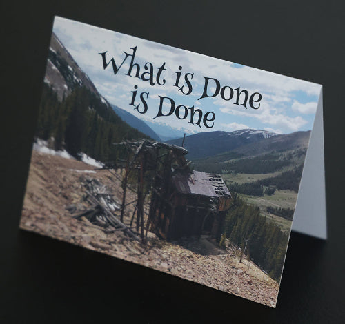 Note card with abandoned mine shack in a mountainous landscape with 'What's done is done' quote.