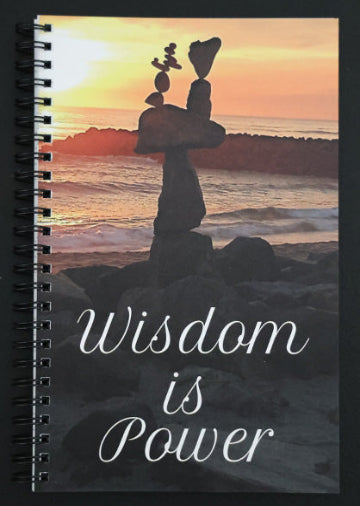 Journal with a cover featuring a sunset over the ocean, with text 'Wisdom is Power'.